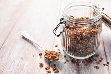 Granola cereal with chocolate and almonds in jar