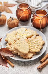 Autumn cookies on plate with cinnamon and fall decor