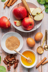 Baking ingredients for apple dessert on wooden table