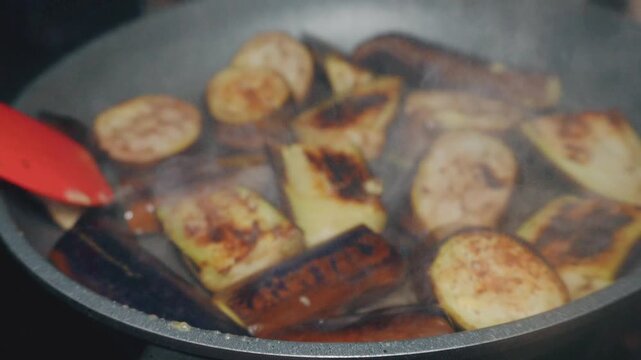 close-up of the process of cooking grilled eggplant in a pan