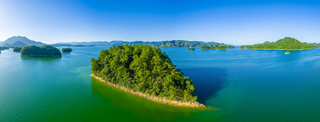 Aerial view of the beautiful lake with green forest islands natural landscape in the morning. Famous Qiandao Lake scenery in Hangzhou, China.
