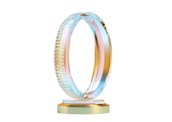 A stylish, gem-encrusted ring stands upright on a gold-toned platform, with a light pink interior