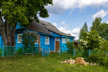 Wooden house in the countryside. Summer in the village. Everyday life in the village and summer holidays in the country. View of a village house.