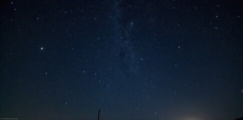 Winter Solstice Starry Night Sky A wide angle shot of a vast, clear night sky filled with countless stars and subtle nebulae, viewed above a snow covered, untouched wilderness. The focus is on the