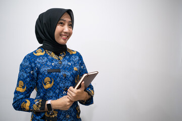 a female dressed in Indonesian Civil Servant uniform or known as KORPRI in isolated white background
