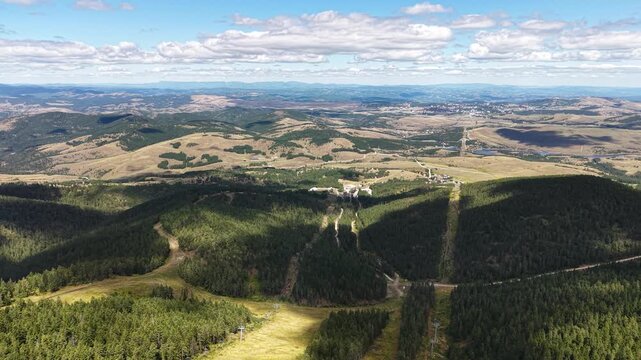 Drone Aerial View of Zlatibor Mountain Landscape, Serbia. Gondola Line, Pine Forest and Hills on Horizon