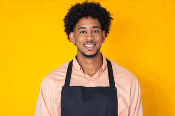 isolated portrait of young man wearing shopkeeper's apron