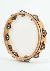 Obraz premium Wooden Tambourine with Metal Jingles on White Background for Music and Instrumental Performance