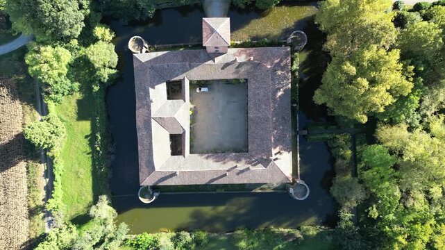 Aerial View of Fortress: An overhead view showcases a majestic fortress, surrounded by a moat and lush greenery, revealing its intricate architectural design and historical grandeur.