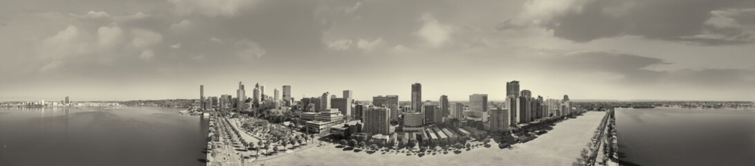 Fototapeta premium Drone shot of Perth cityscape from Swan River showing skyscrapers under bright sunlight