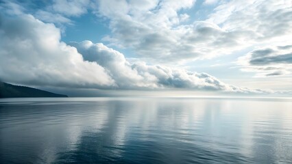 Obraz premium The Sea Horizon Merges Seamlessly Into Misty Silver Morning Clouds, Creating A Dreamlike Scene Where Ocean And Sky Blur Together In Serene Harmony And Ethereal Coastal Tranquility