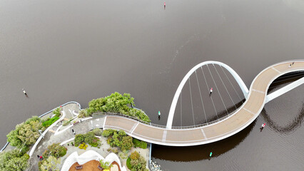 Dramatic sunset sky over Elizabeth Quay bridge with Perth city skyline and waterfront