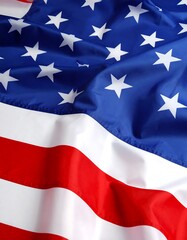 Close-up of an American flag waving, showing the detailed pattern of red and white stripes and white stars