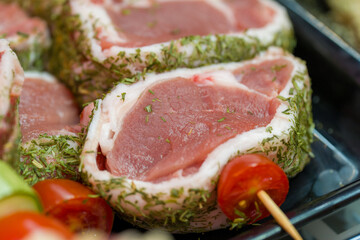 Variety of raw meat packages neatly arranged on supermarket shelves for customers
