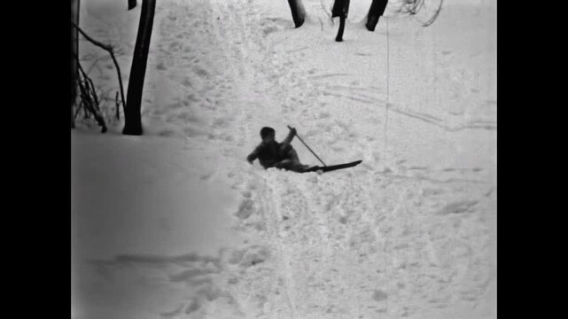 Old archive, Funny man falls down skis on snowy slope in winter forest. Humorous sport crash in snow. Outdoor recreation activity. Fun active leisure accident. Vintage film. Archival retro 1960s video