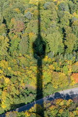 shadow of tall TV-tower on autumn wood below, Stuttgart, Germany