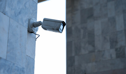 security CCTV camera on the wall in the street