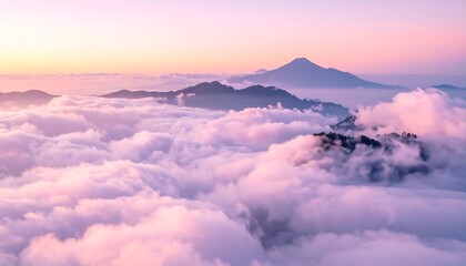 Fototapeta premium Vivid sunrise illuminates cloud-filled valleys and distant mountain peaks