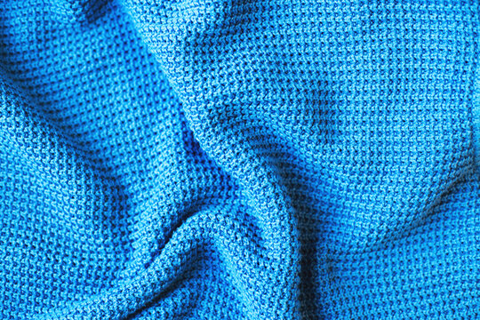 Blue knitted fabric texture with waffle pattern