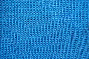 Blue knitted fabric texture with waffle pattern