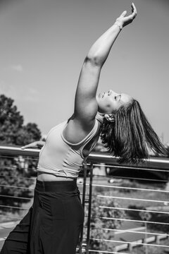 Woman dancer posing stretching outdoors in black and white