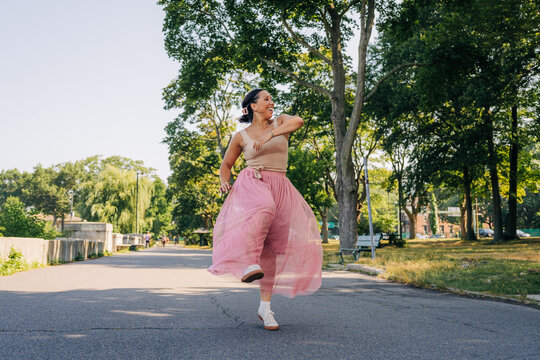 Happy woman dancing outdoors expressing joy and freedom