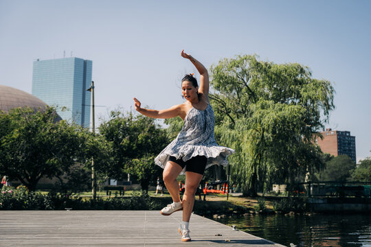 Woman modern dancing outdoors at park boston