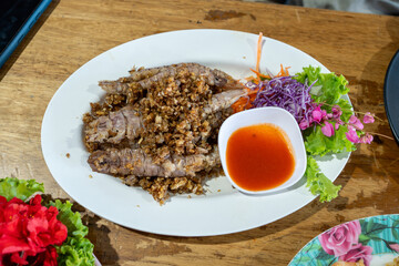 Deep Fried Mantis Shrimp with Crispy Garlic and Chili Sauce on a Wooden Table