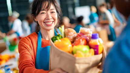Volunteer smiles while handing a grocery bag full of fresh produce at food drive