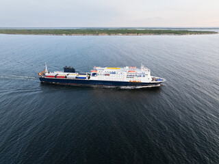Aerial drone view: A large car and passenger ferry sails in the Baltic Sea near the Pakri islands and Paldiski port, Estonia.