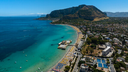 Fototapeta premium Aerial view of Mondello Beach, near Palermo, Sicily, Italy. It is a famous and beautiful tourist destination on the Mediterranean Sea. In background is Mount Pellegrino, overlooking the Tyrrhenian sea