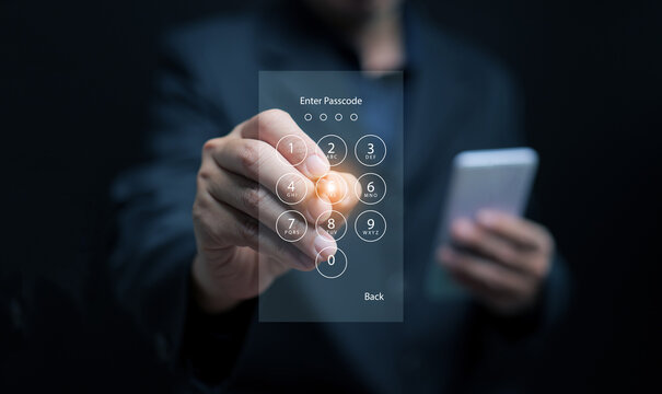 Businessman entering password on virtual keypad for smartphone security, representing data protection, cyber security, and digital privacy technology in modern business environment.