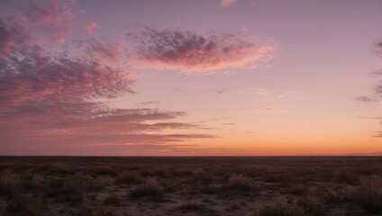 Vibrant Sunset Over Arid Landscape with Pink and Orange Hues.