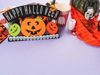 Halloween purple frame background flatlay with pumpkins and party decor