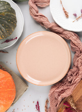 Fall thanksgiving table setting pumpkin decor flatlay with pink dish