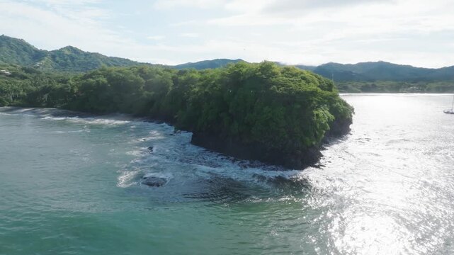 Playa Potrero Costa Rica Aerial Drone Rock and Ocean spin right to left
