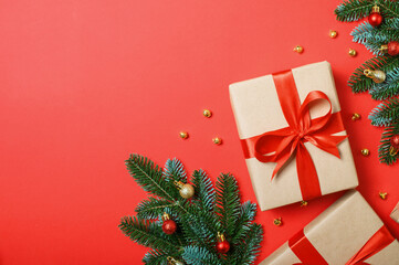 Christmas Gift Boxes with Red Ribbons and Festive Decorations on Red Background