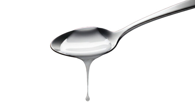 Silver spoon holds white fluid, a drop suspended, dark background