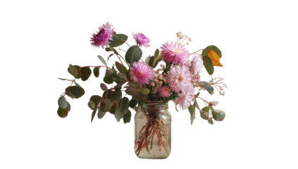 A vibrant bouquet of pink flowers and foliage inside a glass jar, set against a black backdrop