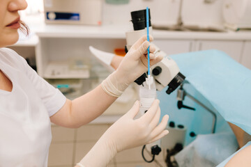 Gynecologist collects a Pap smear sample for cervical screening. Cervical screening procedure with Pap smear tool. Pap smear sample collection.