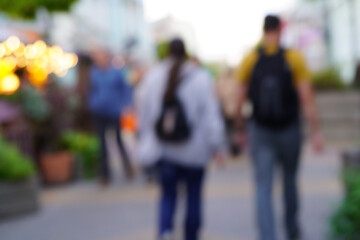 Abstract blurred background. A group of people is walking down the street.