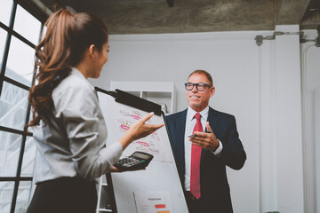 Business people discussing financial strategy during meeting