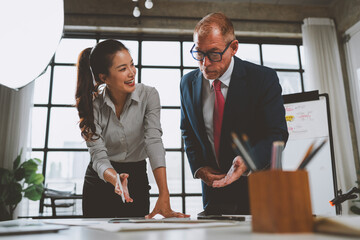 Diverse business team collaborating on project in modern office