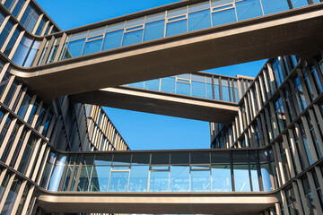 Contemporary architectural bridge structure connecting office buildings in Copenhagen with steel and glass materials under clear sky representing innovative urban design and spatial balance