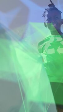 Animation of networks over happy diverse schoolboys in recycling t shirts collecting waste