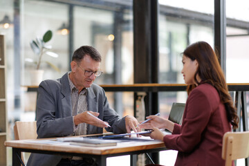 Business colleagues discussing financial documents during meeting