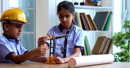 Indian School Kids Studying Crane Mechanism Using 3D Model in Classroom While Wearing School Uniform, Safety Hard Hats, Focused on Engineering Concepts During Academic Activity - Powered by Adobe