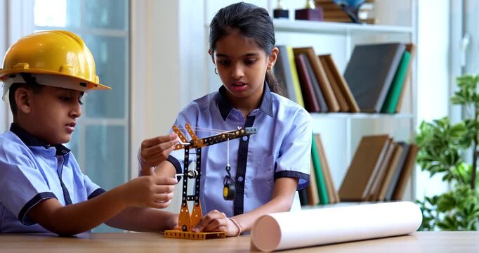 Indian School Kids Studying Crane Mechanism Using 3D Model in Classroom While Wearing School Uniform, Safety Hard Hats, Focused on Engineering Concepts During Academic Activity