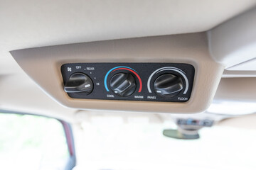 Close-up interior view of overhead console controls in a 2004 American 4x4 family SUV showing...