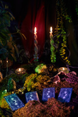 Tarot cards rest on a bed of moss, accompanied by flickering candles and plants, creating a serene atmosphere. soft light adds a magical touch to the scene
